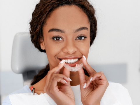 girl putting in invisalign