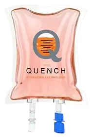 Quench Hydration Technology IV bag with orange liquid, soft studio lighting, and dark grey logo branding on a transparent plastic medical pouch.