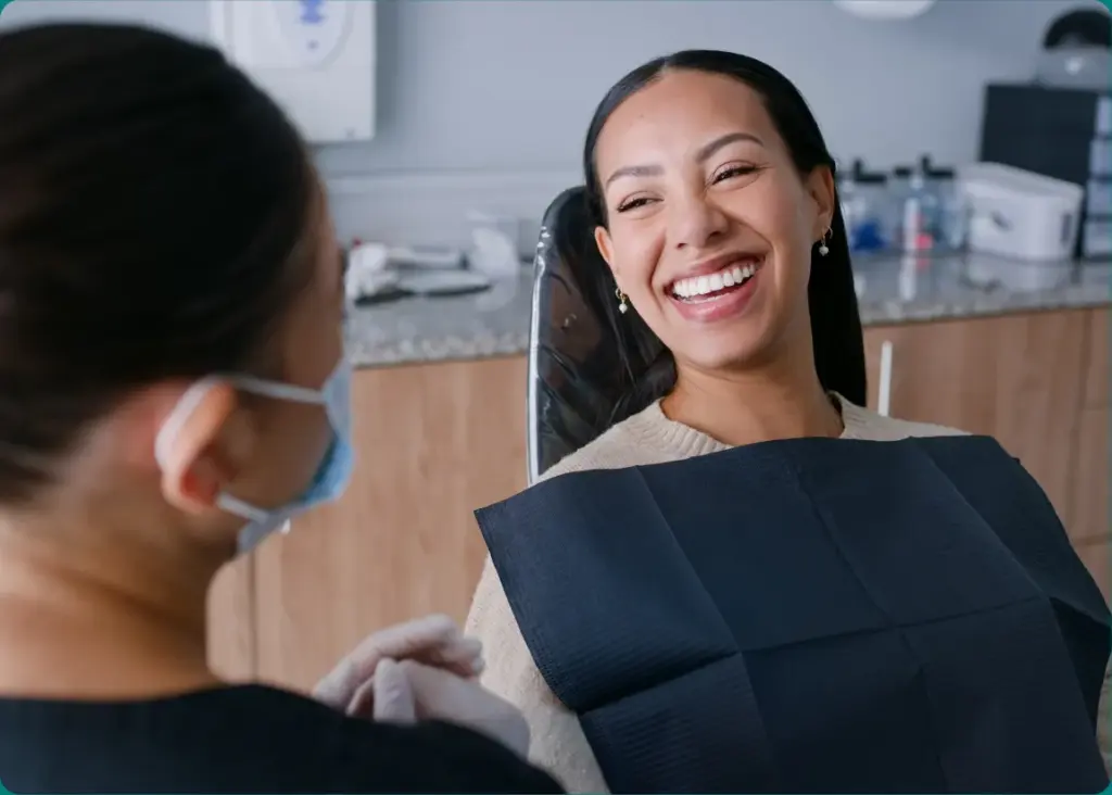 Patient smiling in the dental chair after professional teeth whitening at Premiere Dental Spa